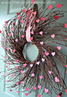 a heart shaped wreath hanging on the front door