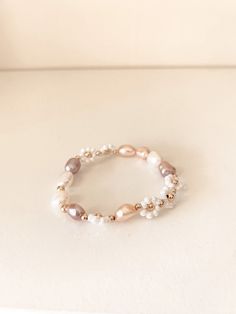 Delicate and feminine, our Eva Bracelet is the perfect everyday piece. Featuring 8mm freshwater pearls framed with our golden white daisies, this bracelet will make you feel confident and absolutely sparkle. Materials: A mix of 8 mm freshwater pearls, white glass seed bead daisies, 3 mm & 4 mm gold filled bead accents Rose Gold Pearl Beaded Bracelets, Feminine White Pearl Bracelets, Feminine White Pearl Bracelet, White Feminine Bracelets With Round Beads, Everyday White Pearl Beaded Bracelets, White Round Beads Feminine Bracelet, Feminine Adjustable White Pearl Bracelet, Adjustable Feminine White Pearl Bracelet, White Feminine Round Bead Bracelets