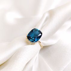 This stunning ring is set in 14k Solid Yellow Gold with Natural London Blue Topaz with utmost precision. It is a unique statement gemstone ring for nearly every occasion and is completely hassle-free jewelry. ITEM DETAILS: * GEM: London Blue Topaz * GEM SIZE: 10X12mm * GEM SHAPE: Cushion cut * GEM WEIGHT: 5.96 carats * Gold Purity: 14KT * Gold Weight: 1.73 gram * Total Weight of the Ring: 2.92 gram The Gold purity is guaranteed and it comes with authentic 14KT gold hallmark. Since my items are h London Blue Engagement Ring, Cushion Cut Topaz Ring With Prong Setting As Gift, Gift Cushion Cut Blue Topaz Ring, Blue Cushion Cut Topaz Ring Gift, Gift Blue Topaz Cushion Cut Ring, London Blue Topaz Jewelry, November Birthstone Ring, Blue Engagement Ring, Handmade Jewelry Box