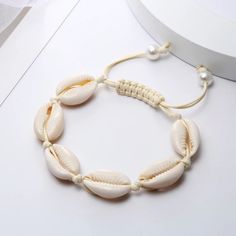 Bohemian Cowrie Puka Shell Bracelet Adjustable Natural & Natural Hand Knit Rope Natural Color Strand Bracelet 6 Puka Shells 2 Faux Pearl Accents Bohemian Natural Sea Shell Bracelets Anklet Hand Knit Rope Elastic Beaded Pulsera Diy Beach Jewelry Accessories Summer Women Miami Beach Trends Trendy Gift Bff Small Bundle And Save Elegant White Friendship Bracelets For Beach, Handmade Beige Bracelets For Vacation, Elegant Beige Beaded Bracelets For Beach, Bohemian Beige Bracelets For Vacation, Adjustable Cream Bracelet For Summer, Adjustable Cream Bracelets For Summer, Bohemian Beige Bracelet For Vacation, Beige Bohemian Bracelets For Vacation, Adjustable Beige Bracelet For Vacation