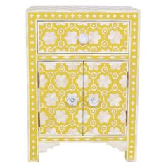 a yellow and white cabinet sitting on top of a table