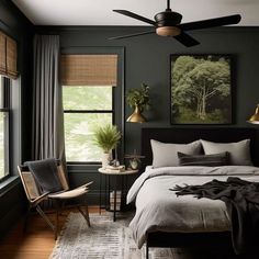 a bedroom with dark green walls and white bedding