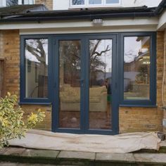 a living room with sliding glass doors on the outside