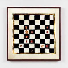 a black and white checkered board with gold trimmings is mounted on a wall