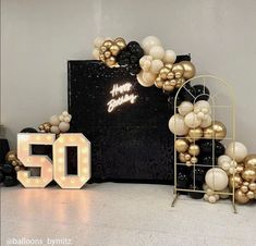 a 50th birthday party with balloons and lights in the shape of numbers, including 50