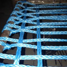 blue rope is attached to the side of a metal structure that has been placed on top of it