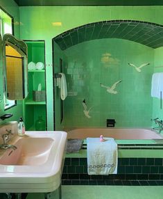 a bathroom with green tile and pink bathtub