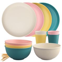 a bunch of different colored bowls and plates