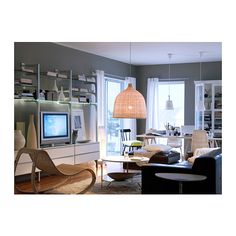 a living room filled with furniture and a flat screen tv sitting on top of a wooden shelf