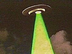 an alien flying through the night sky with a green light on it's head