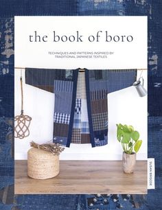 the book of boro is displayed on a shelf next to a potted plant