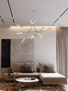 a living room with a couch, coffee table and chandelier in the middle