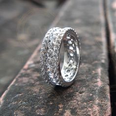 a diamond ring sitting on top of a rock