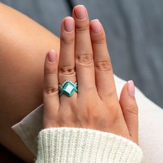 a woman's hand with a ring on it