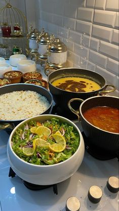 a table topped with lots of different types of dishes and bowls filled with food on top of it