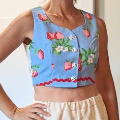 "One-of-a-kind piece! This is a newly-handmade top, made from a vintage pattern with vintage fabric and notions. The fabric on the front is from a cotton tablecloth, a cute strawberry print. It had damage, and couldn't be used as a tablecloth anymore, so we re-purposed the \"good parts\". The back fabric is a fine weave white cotton with blue cross-stitch. The back fabric is from an antique doily... like a \"mini tablecloth\". Fully lined in cotton. Red ric-rac accent. White plastic buttons. Fit Tablecloth Top, Motif Vintage, Cute Strawberry, Blue Cross, Strawberry Print, Vintage Tablecloths, Ric Rac, Cotton Tablecloths, Top Cropped