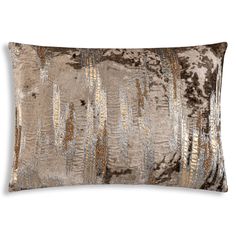 a brown and silver pillow with metallic foiling on the front, along with a white background