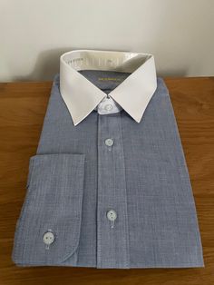 "Vintage unworn blue shirt with solid white collar in polyester cotton mix by Acuman.  Details: point collar, long sleeves, single cuff, regular fit.  Size 15 1/2\" 39/40cm" Classic Navy Cotton Dress Shirt, Blue Shirt With Concealed Placket And Fold Down Collar, Classic Tailored Blue Dress Shirt, Blue Business Shirt With Fold Down Collar, Cotton Shirt With Contrast Collar Long Sleeve, Cotton Shirt With Contrast Collar And Long Sleeves, Blue Office Shirt With Concealed Placket, Blue Formal Shirt With Fold Down Collar, Blue Shirt With Concealed Placket For Office