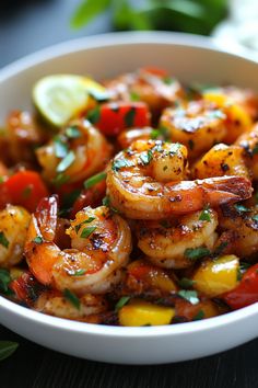 Grilled shrimp with chopped red and yellow bell peppers, garnished with herbs and lime wedges in a white bowl. Mediterranean Shrimp Dishes, Mushroom And Shrimp Recipes, Baileys Fudge, Shrimp Bowl