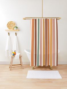 a bathroom with a striped shower curtain next to a white bath tub and wooden stool