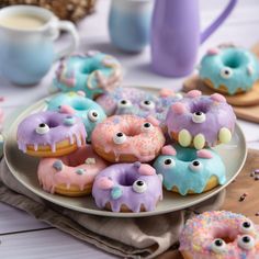 there are many decorated donuts on the plate with sprinkles and eyes