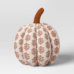 an orange and white pumpkin sitting on top of a table