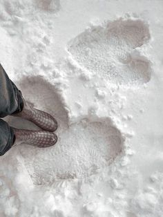 a man sitting in the snow with his feet up