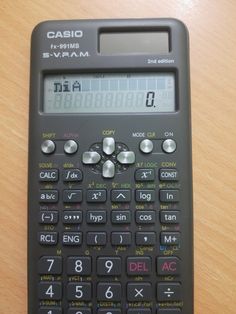 a calculator sitting on top of a wooden table