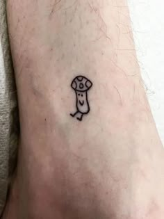 a small tattoo on the ankle of a person's foot with a mushroom on it