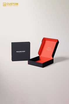 an open black and red box sitting on top of a white table next to a gray wall