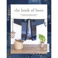 the book of boro is displayed on a shelf next to a potted plant