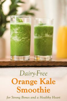 two glasses filled with orange kale smoothie