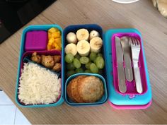 a lunch box with rice, fruit, and other foods in it on a table