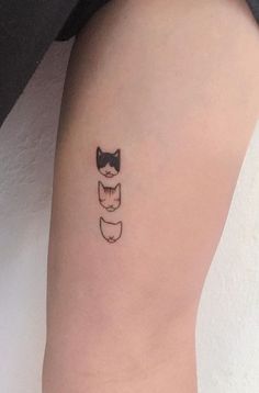 a small black cat tattoo on the arm