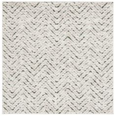 a white rug with grey and black zigzag pattern