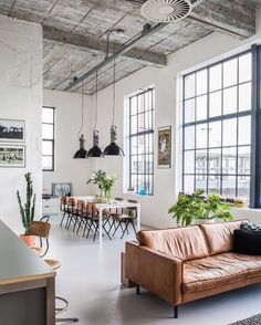 a living room filled with furniture and lots of windows