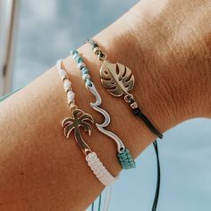 Adjustable Colorful Beach Bracelets with a cute Charm for that summer look. Super Dainty and great for stacking or creating that unique surfer girl beach look.. Perfect as a gift to yourself or for that special beach person in your life! Pair it with our unique shark bracelets! Choose: ♡ Nylon Bronze with Silver Wave - Lead and Nickle Free ♡ Nylon Teal with Silver Wave - Lead and Nickle Free ♡ Nylon White with Gold Palm Tree - 24K plated ♡ Nylon Green with Gold Monstera Leaf - 24K plated ♡ Closu Adjustable Jewelry For Beach Vacation, Adjustable Summer Jewelry Gift, Casual Jewelry With Sliding Knot For Vacation, Vacation Strand Bracelets With Sliding Knot, Summer Beach Bracelets With Sliding Knot, Adjustable Friendship Bracelets For Beach Vacation, Adjustable Friendship Bracelets For Beach Season Vacation, White Friendship Bracelets For Beach Party, Adjustable Beachy Jewelry For Beach Party