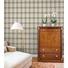 a living room scene with focus on the chest of drawers and wall paper behind it