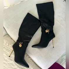 It’s Giving Luxury. These Boots Have A Vegan Leather Construction, A Pointed Toe Design, Gold Finish Stiletto Heels, Wrap Around Ankle Buckle Closures With A Gold Lock And Key Charm On The Sides, And Side Zipper Closures. Heel Height: 4.25" Approx Elegant Fitted Knee-high Boots With Buckle Closure, Office High Heel Boots With Buckle Closure, Office Heeled Boots With Buckle Closure High Heel, Office High Heeled Boots With Buckle Closure, Chic Knee-high Heels For Wide Calf, Chic Knee-high Heels For Night Out, Chic Faux Leather Knee-high Boots With Closed Toe, Elegant Faux Leather Knee-high Boots For Evening, Trendy Heeled Boots With Buckle Closure For Formal Occasions