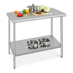 a stainless steel table with two pots and pans on it