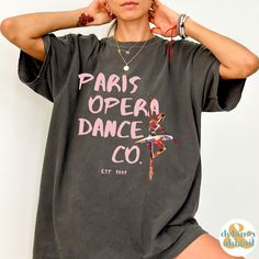 You will absolutely LOVE this trendy Paris Opera Dance Company Ballet Shirt. The perfect gift for the dancer in your life. Comfort Colors introduces the soft-washed, 100% ring-spun cotton, garment-dyed fabric that brings extra coziness to your wardrobe while the relaxed fit makes it an excellent daily choice. The double-needle stitching throughout the tee makes it highly durable while the lack of side-seams helps the shirt retain its tubular shape.  ❤ The Comfort Colors 1717 tee is made with medium fabric (6.1 oz/yd² (206.8 g/m      consisting of high quality, 100% ring-spun US cotton for long-lasting comfort. ❤ The relaxed fit keeps the wearer comfy in both casual and semi-formal settings      while the crew neckline delivers that classic, neat style which makes it perfect      for access Relaxed Fit T-shirt For Dance With Short Sleeves, Fitted Hip Hop T-shirt For Dance, Fitted Cotton T-shirt For Dance Class, Stretch Cotton T-shirt For Dance Class, Fitted Crew Neck T-shirt For Dance Class, Fitted Crew Neck T-shirt For Dance, Fitted Hip Hop Dance T-shirt, Hip Hop Crew Neck Top For Dance, Hip Hop Style Crew Neck Top For Dance