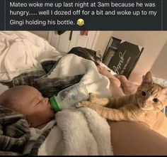 a baby laying on top of a bed next to an orange and white cat with a bottle in it's mouth