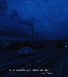 a car driving down the road at night with a quote on it that reads he will soothe the hearts of those who believe