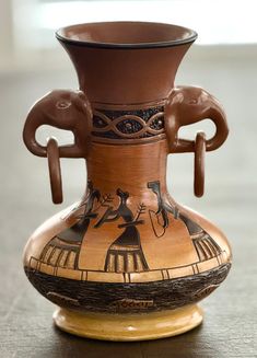 an ancient vase is sitting on the table