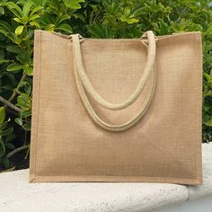 a beige bag sitting on top of a stone bench