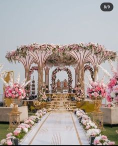 an outdoor wedding setup with pink flowers and greenery