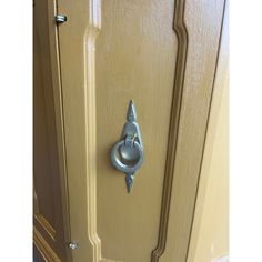 a door handle on the side of a yellow cabinet