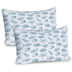 two blue and white pillows with seashells printed on the front, one is made from