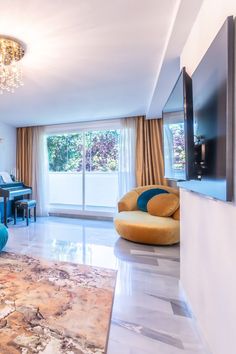 a living room filled with furniture and a flat screen tv