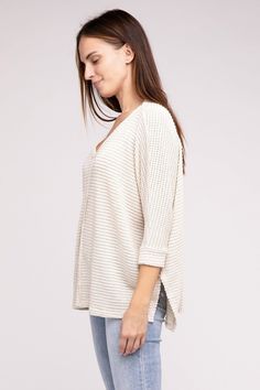 Elevate your spring wardrobe with our Zenana Waffle Knit 3/4 Sleeve Top. This lightweight top features a comfortable oversized fit. The V-neckline and hi-low hem add a touch of elegance, while the side slits provide extra comfort. Dress it up with white jeans or dress pants or keep it casual with denim shorts or jeans. You'll love the versatility of this waffle top! Neckline: V-neckline Features: Side Slits Fabric: Waffle knit texture Hemline: Hi-low hem Sheer: Semi-sheer Sleeve: 3/4 Sleeve Stre Soft Knit V-neck Sweater For Spring, Spring Oversized Waffle Knit Tops, Oversized Waffle Knit Tops For Spring, Casual Textured Knit Top For Spring, Textured Tops For Spring Loungewear, Spring Textured Tops For Loungewear, Casual Spring V-neck Open Knit Sweater, Spring Casual Open Knit V-neck Sweater, Casual Open Knit V-neck Sweater For Spring